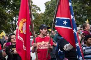 Tea Party Idiot waves Confederate Flag at UNITED STATES VETERANS Protest