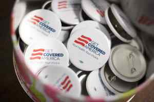 Get Covered America buttons are seen during a training session in Chicago